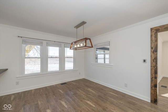 unfurnished dining area with ornamental molding and dark wood-type flooring