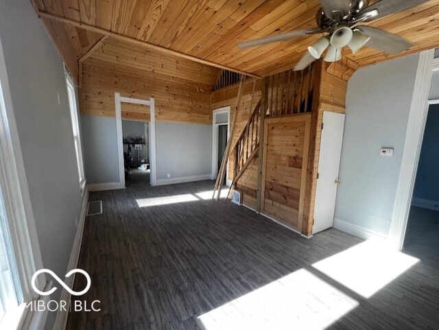 spare room with ceiling fan, dark hardwood / wood-style flooring, lofted ceiling, and wooden ceiling