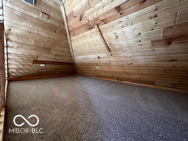 bonus room with carpet flooring, wood walls, lofted ceiling, and wooden ceiling