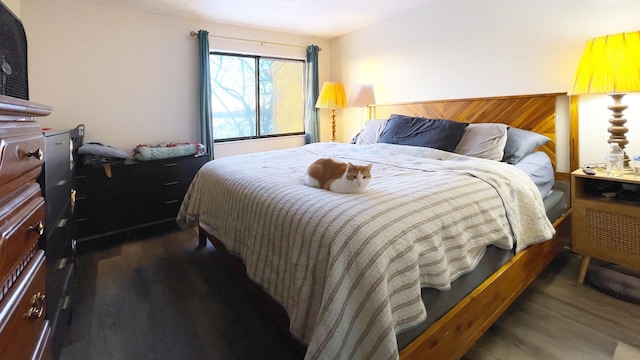 bedroom with wooden walls and dark hardwood / wood-style floors