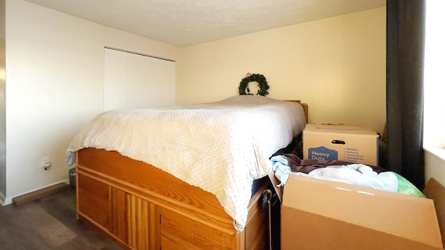 bedroom featuring dark hardwood / wood-style flooring and a closet