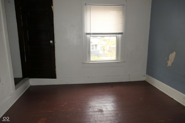 spare room featuring dark hardwood / wood-style floors