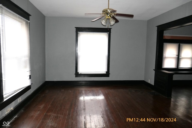 spare room with ceiling fan and dark wood-type flooring