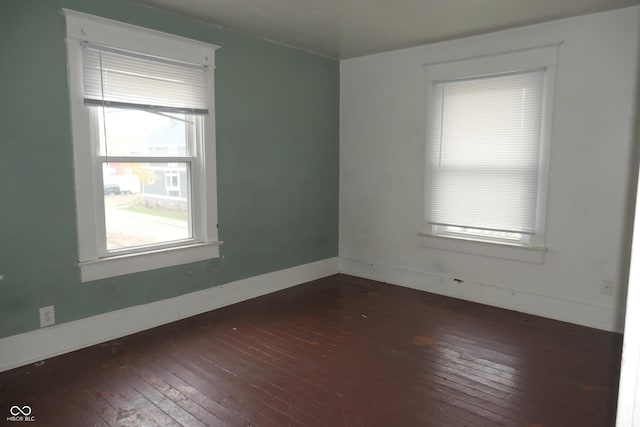 unfurnished room with dark hardwood / wood-style floors