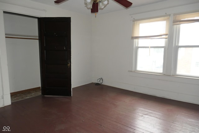 unfurnished bedroom featuring ceiling fan and dark wood-type flooring