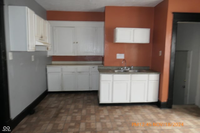 kitchen featuring white cabinets and sink