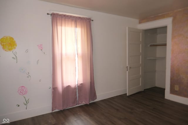 unfurnished bedroom featuring dark wood-type flooring