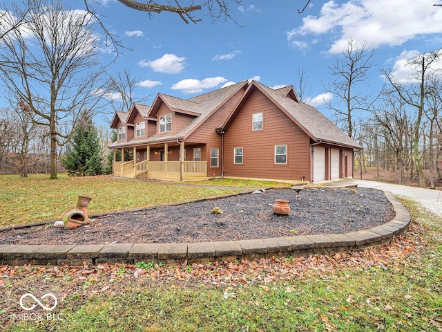 view of home's exterior featuring a porch, a yard, and a garage