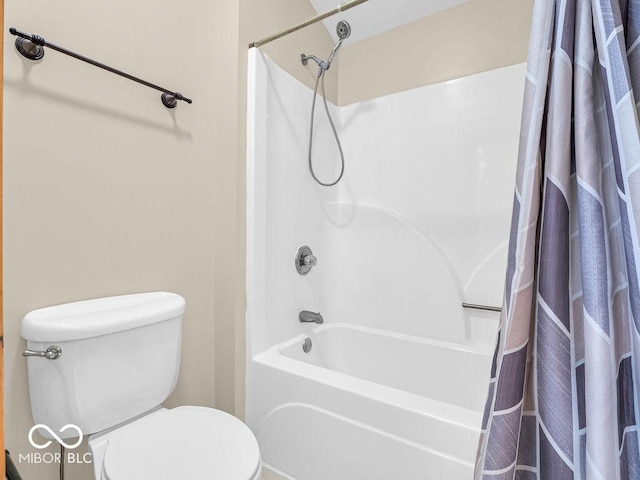 bathroom with toilet and shower / bath combo with shower curtain