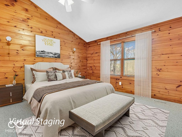 bedroom featuring carpet flooring, wooden walls, ceiling fan, and vaulted ceiling