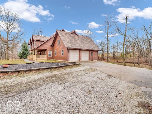 view of property exterior featuring a porch and a garage