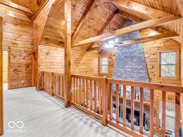 hall featuring wood walls, carpet floors, and wood ceiling