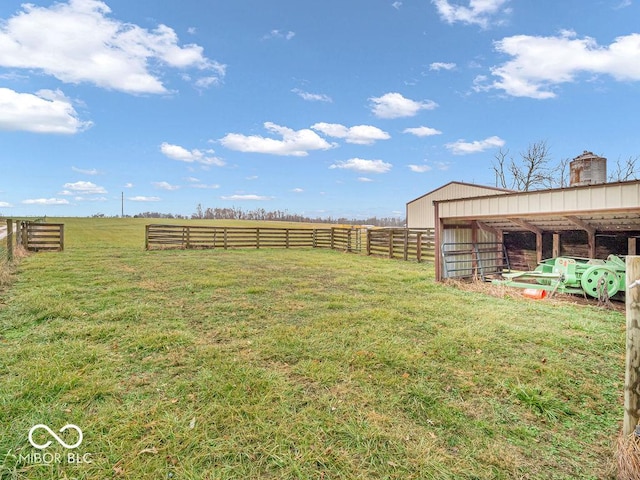 view of yard with a rural view and an outdoor structure