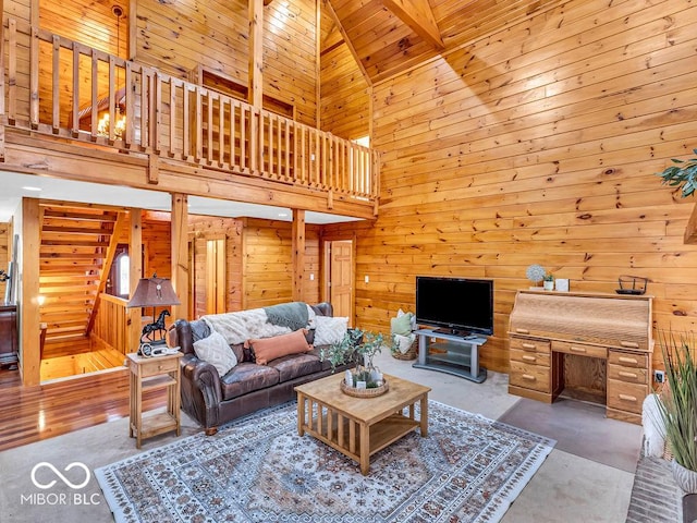 living room featuring wood ceiling, wooden walls, high vaulted ceiling, beamed ceiling, and concrete floors