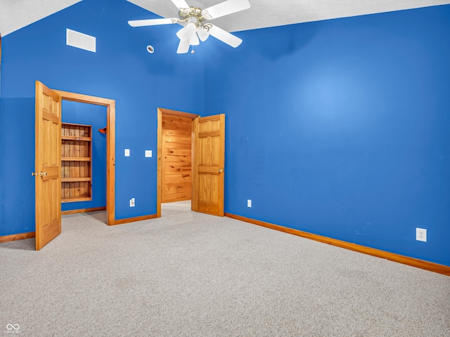 unfurnished bedroom with a textured ceiling, carpet floors, high vaulted ceiling, and ceiling fan