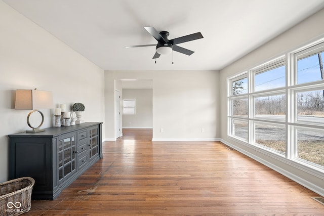 unfurnished room featuring dark hardwood / wood-style floors and ceiling fan