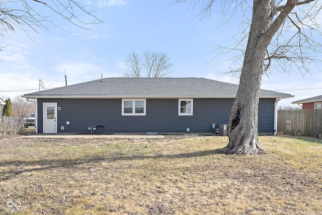 back of house featuring a yard and central air condition unit