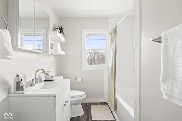 full bathroom featuring vanity, wood-type flooring, shower / bath combination with curtain, and toilet