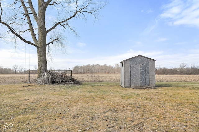 view of yard with a storage unit and a rural view