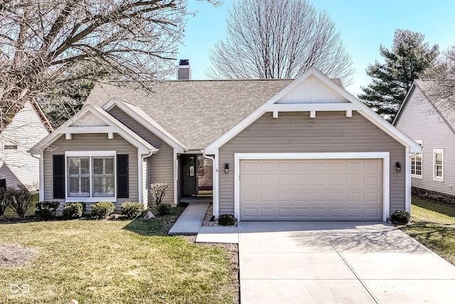 view of front of home featuring driveway, roof with shingles, a front yard, an attached garage, and a chimney