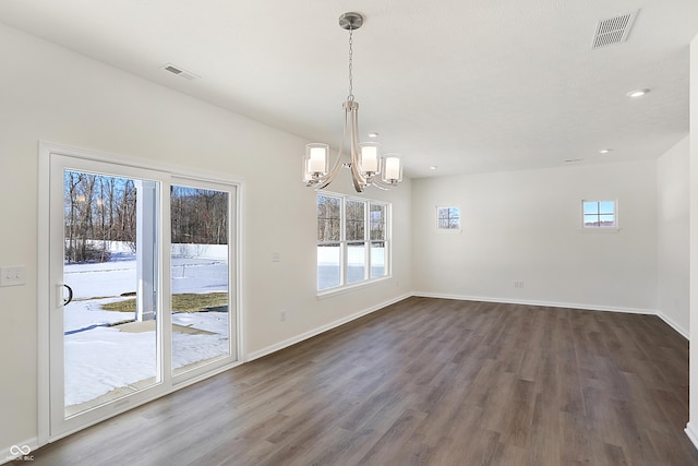 unfurnished dining area featuring dark hardwood / wood-style floors and a notable chandelier