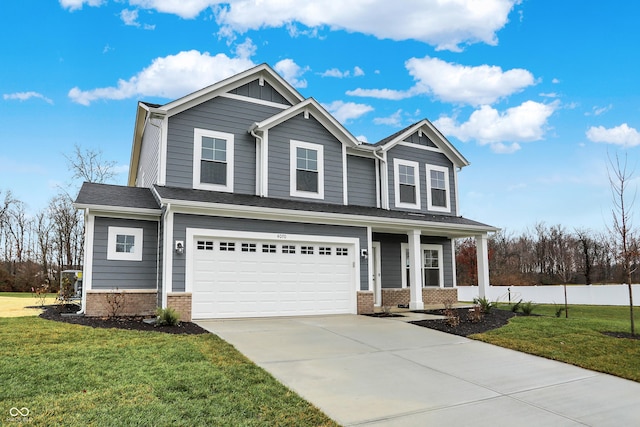 craftsman-style home featuring a front lawn, covered porch, and a garage