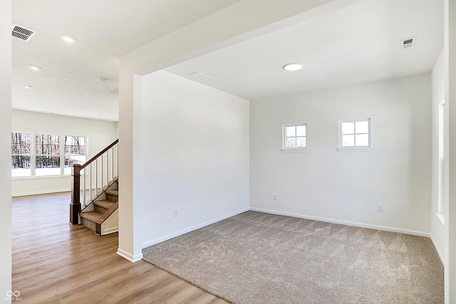 spare room with a healthy amount of sunlight and hardwood / wood-style flooring