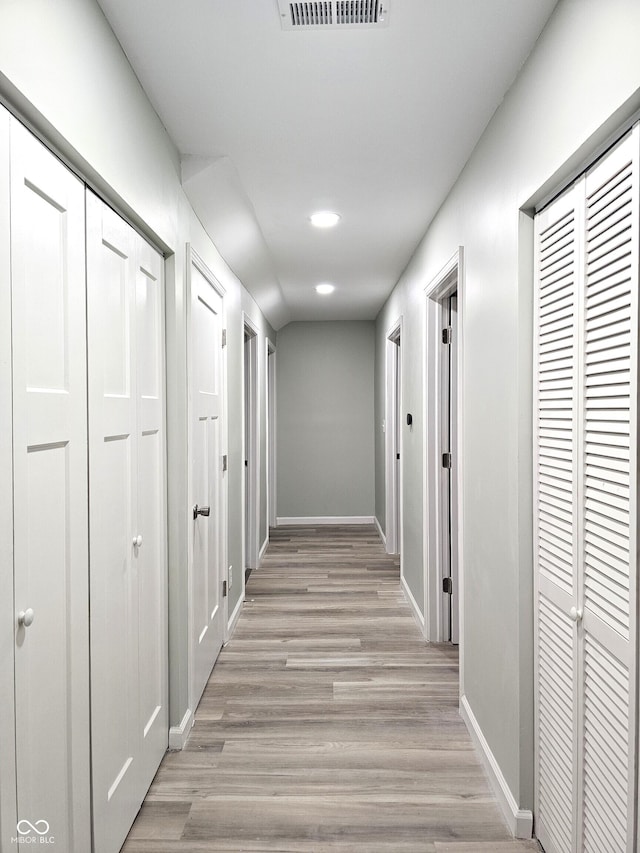 corridor featuring light hardwood / wood-style floors