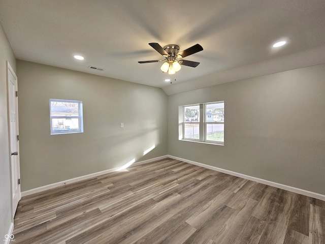 unfurnished room with ceiling fan, wood-type flooring, and a healthy amount of sunlight