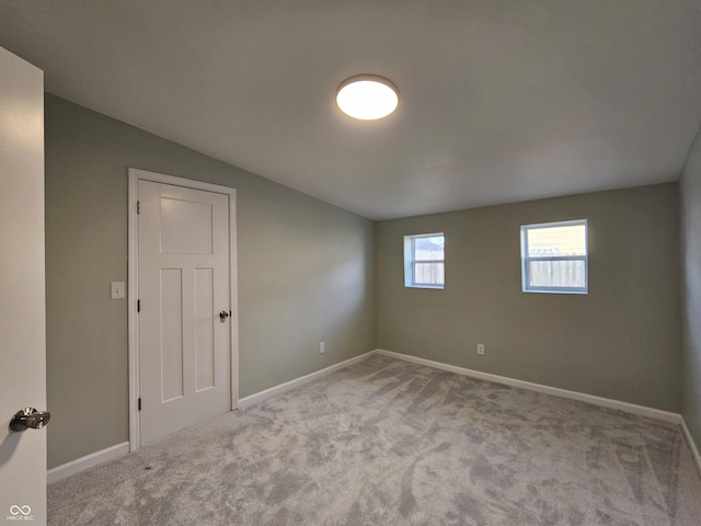 unfurnished room featuring light carpet