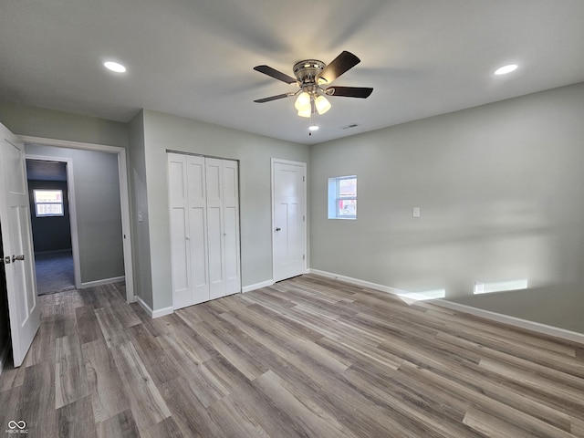 unfurnished bedroom featuring ceiling fan and light hardwood / wood-style floors