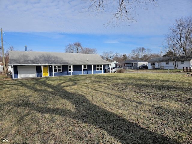 ranch-style home with a front lawn and a garage