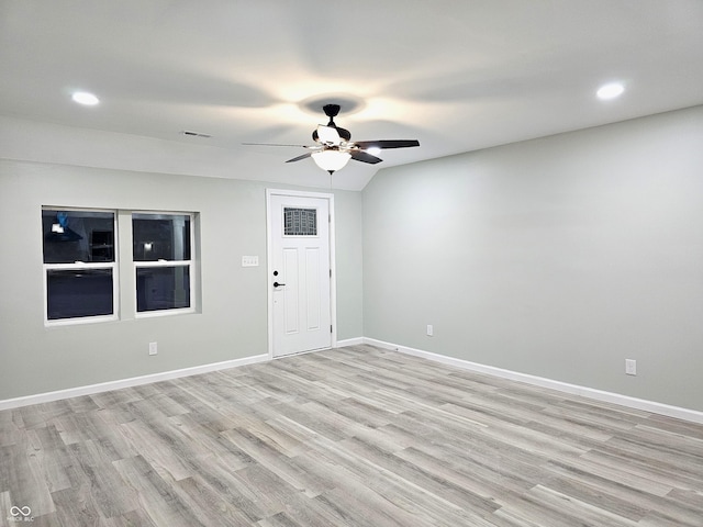 spare room featuring ceiling fan, light hardwood / wood-style flooring, and vaulted ceiling