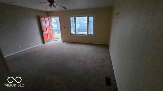 carpeted spare room featuring ceiling fan