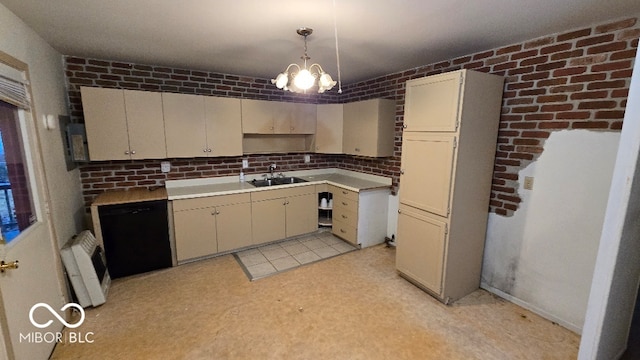 kitchen featuring pendant lighting, sink, brick wall, and an inviting chandelier