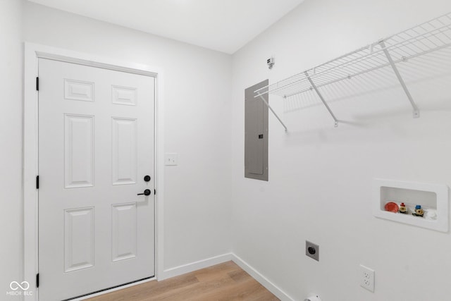 laundry area with electric panel, hookup for a washing machine, light wood-type flooring, and hookup for an electric dryer