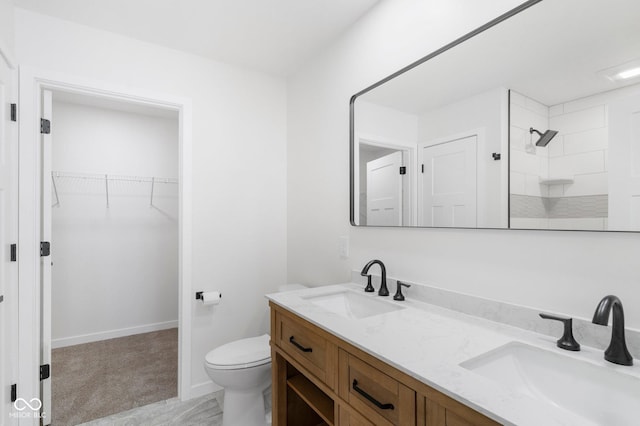 bathroom featuring vanity, toilet, and walk in shower