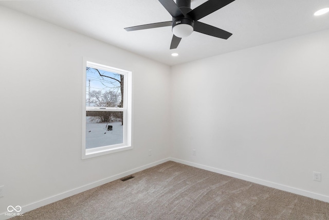 unfurnished room with ceiling fan and carpet floors