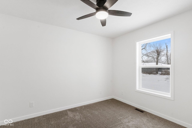 spare room with a wealth of natural light, carpet, and ceiling fan