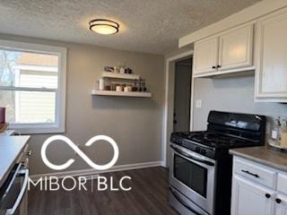 kitchen featuring white cabinets, a textured ceiling, and stainless steel range with gas stovetop