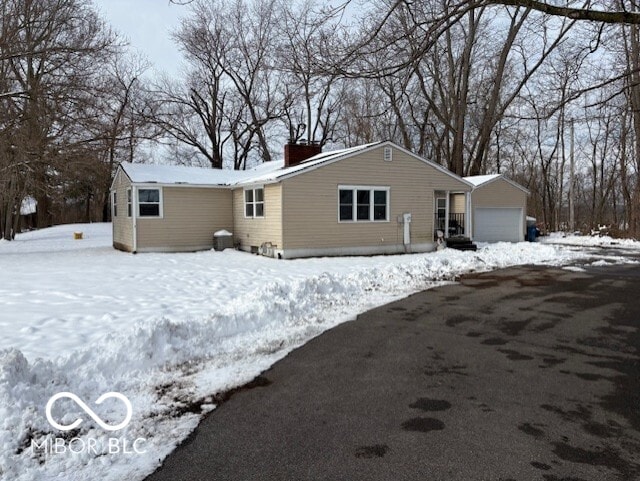 view of snow covered rear of property