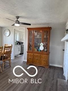 dining space with ceiling fan and dark wood-type flooring