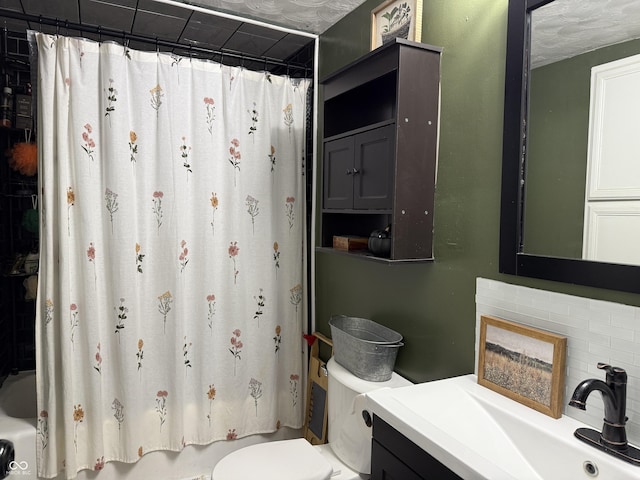 full bathroom featuring backsplash, vanity, a textured ceiling, shower / bathtub combination with curtain, and toilet