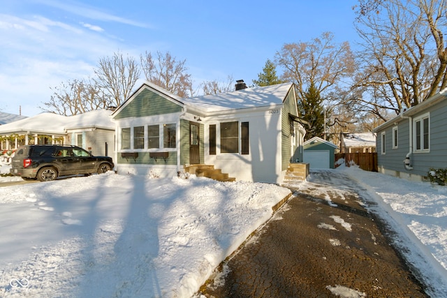 bungalow with an outbuilding and a garage