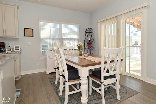 dining space with dark hardwood / wood-style floors