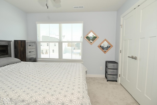 carpeted bedroom with a closet and ceiling fan