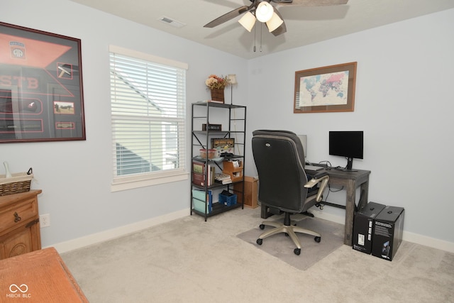 office area with ceiling fan, a healthy amount of sunlight, and light carpet