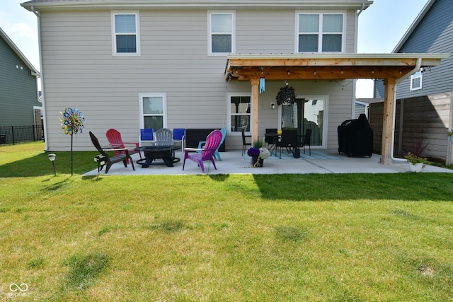 back of house featuring a lawn and a patio