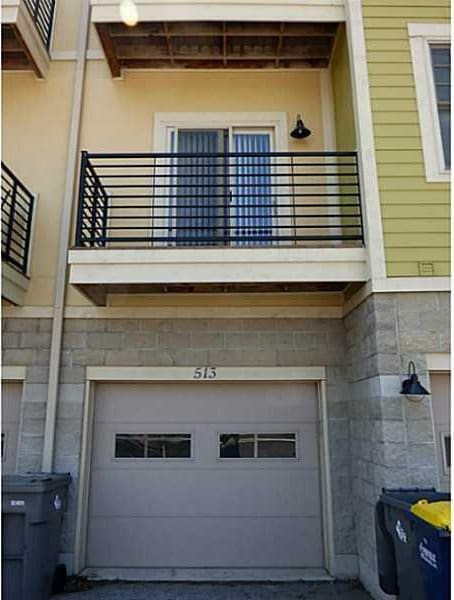 exterior space with a garage and a balcony