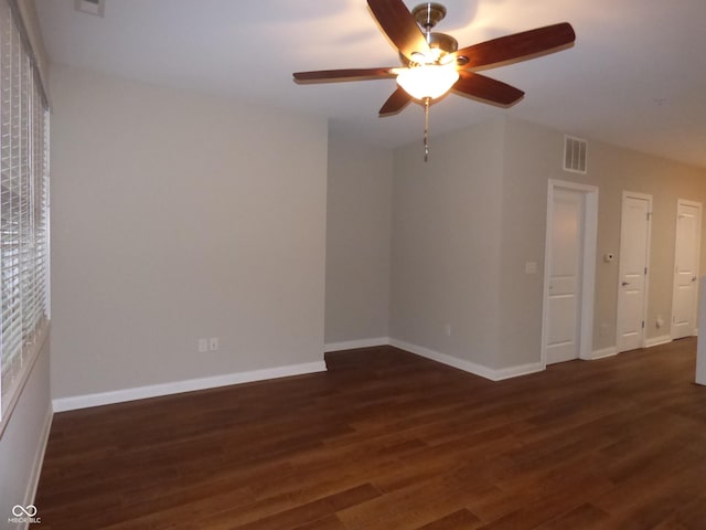 unfurnished room featuring ceiling fan and dark hardwood / wood-style flooring